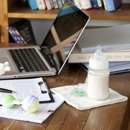 Photo of bottle of milk near laptop