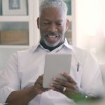 man holding an ipad